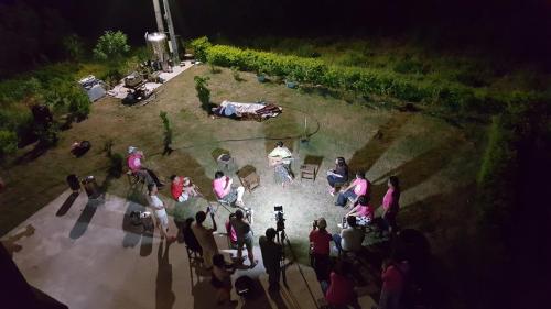 a group of people standing around a garden at night at 好宿民宿 in Jinning