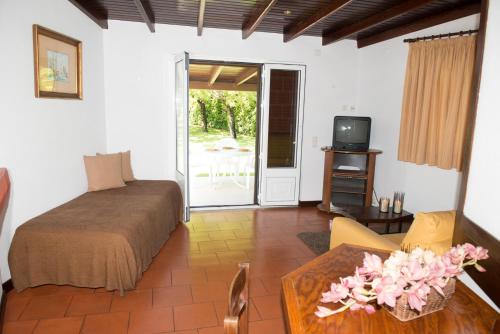 a bedroom with a bed and a table and a tv at Hotel S. Jorge in Batalha