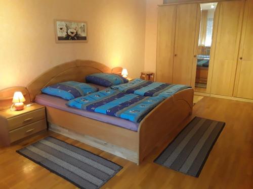 a bedroom with a large bed with blue pillows at Ferienhaus Nicole in Piesport