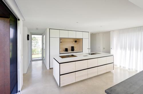 a kitchen with white cabinets and a counter at Seestück Prerow in Prerow