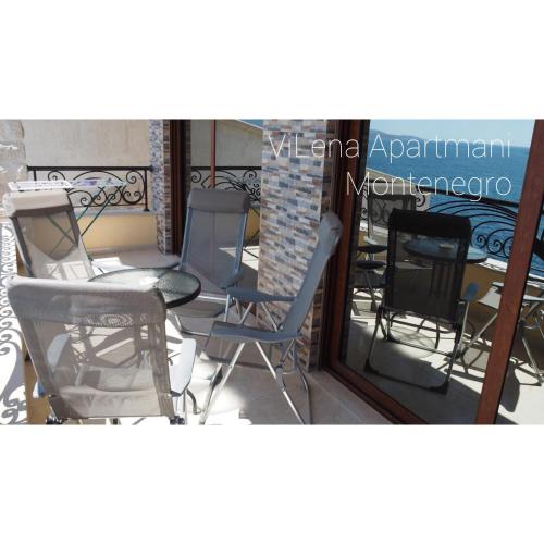a group of chairs sitting on a balcony at ViLena Apartmani in Tivat