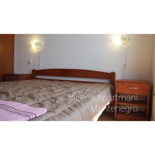 a bedroom with a bed and a dresser at ViLena Apartmani in Tivat