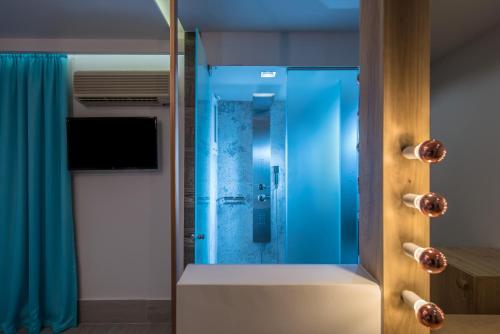 a bathroom with a shower with blue glass at Senses Blue Boutique hotel in Hersonissos