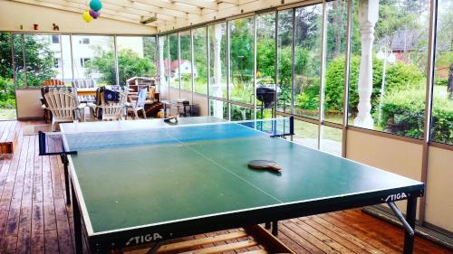 a ping pong table in a room with windows at Nordic character in Vidsel
