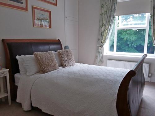a bedroom with a bed and a window at Chine Side in Shanklin