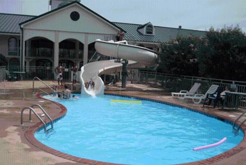 a swimming pool with a water slide in a house at Americana Inn - Henderson in Henderson