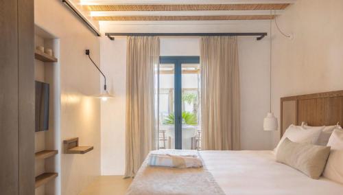 Кровать или кровати в номере Branco Mykonos