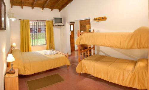 Ένα ή περισσότερα κρεβάτια σε δωμάτιο στο Posada Jardin del Cerro