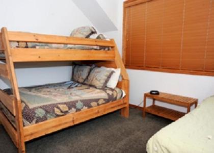 a bedroom with two bunk beds and a table at Zion Ponderosa Ranch Resort in Springdale