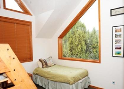 a bedroom with a bed in a room with a window at Zion Ponderosa Ranch Resort in Springdale