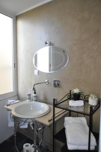 a bathroom with a sink and a mirror on the wall at Cativos - Alfama Center District in Lisbon