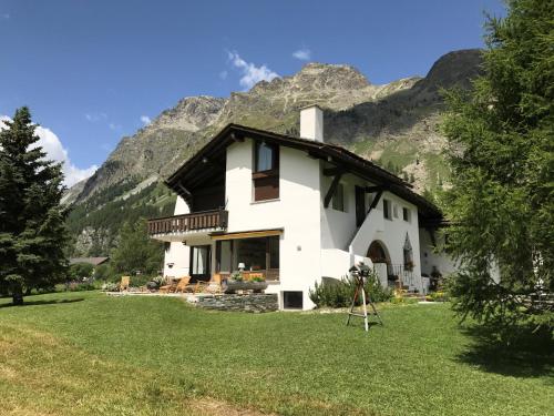 a house with a camera in front of a mountain at Chesa Suot Ovas in Sils Maria