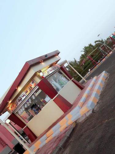 a fast food restaurant with a sign in front of it at Hotel & Resort Golden Marina Yanbu in Yanbu