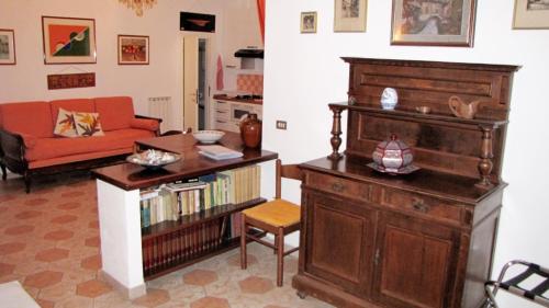 セストリ・レヴァンテにあるLa Casa delle Vitiのリビングルーム(本棚、ソファ付)