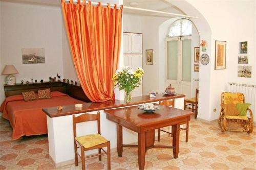 a bedroom with a bed and a desk and a table at La Casa delle Viti in Sestri Levante