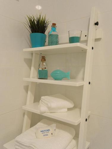 a shelf in a bathroom with towels on it at Always Porto in Vila Nova de Gaia