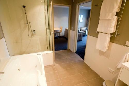 a bathroom with a shower, sink, and toilet at The Crown Hotel in Napier