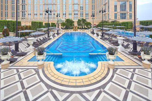 a large swimming pool in front of a building at The Parisian Macao in Macau