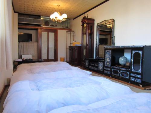Postel nebo postele na pokoji v ubytování Ryokan Matsukaze