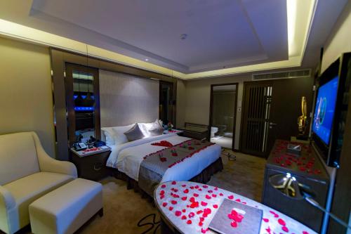 a hotel room with two beds and a television at Braira Al Olaya in Riyadh