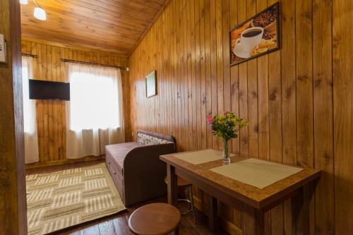 a living room with a table and a couch at Panorama Dofinovka in Nova Dofinivka