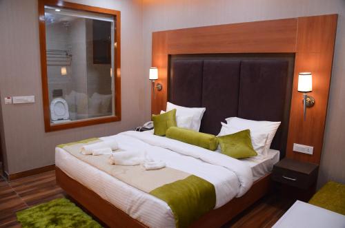 a bedroom with a large bed with towels on it at Platinum Palace in Gurgaon
