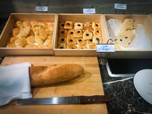 a box of bread and pastries on a cutting board at Chongqing Liyuan Hotel in Chongqing