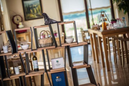 a shelf with a bottle of wine and a basket at Agriturismo La Pertica in Costermano sul Garda