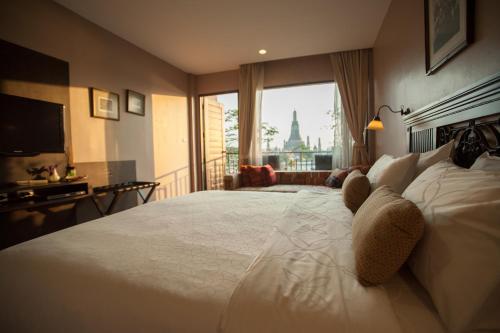 Кровать или кровати в номере Sala Arun