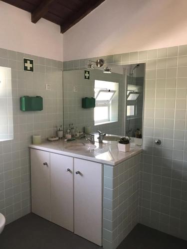 a bathroom with a sink and a mirror at Monte de Sao Francisco in São Miguel de Machede