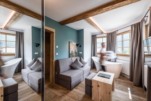 a living room with a couch and a table at Strasserwirt - Ansitz zu Tirol in Strassen