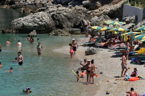 a group of people on the beach at a beach at Hotel Nimfa in Vlorë