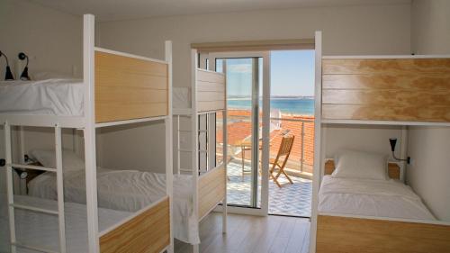 a bedroom with bunk beds and a view of the ocean at Topcity Hostel & Suites in Lagos