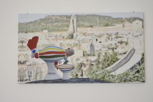 a toy chicken sitting on a table with a view at B&B Fontana La Stella in Gravina in Puglia
