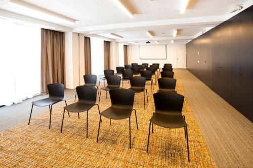 a row of chairs in a room with a screen at Bordoy Cosmopolitan in Playa de Palma