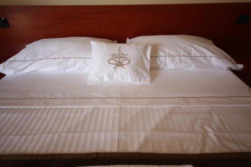 ザンブローネにあるLa Rosa dei Ventiの白い枕(クロス付)が備わる白いベッド