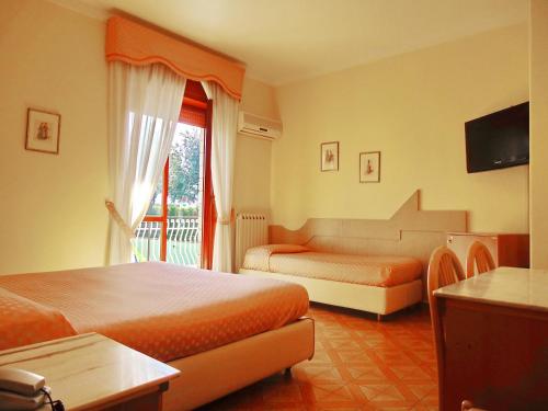 Postel nebo postele na pokoji v ubytování Hotel Giovanna