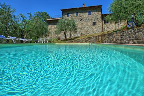 a large pool of water in front of a building at Villa Poggio Conca by PosarelliVillas in Incisa in Valdarno