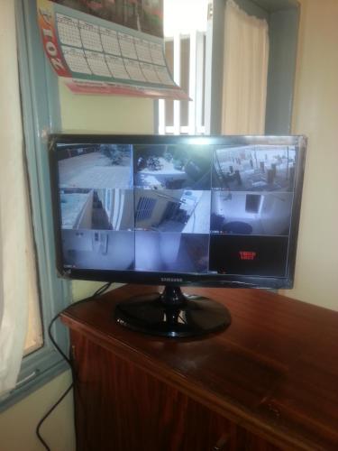 a flat screen tv sitting on top of a wooden table at Residence Le Cailcedrat in Ouagadougou