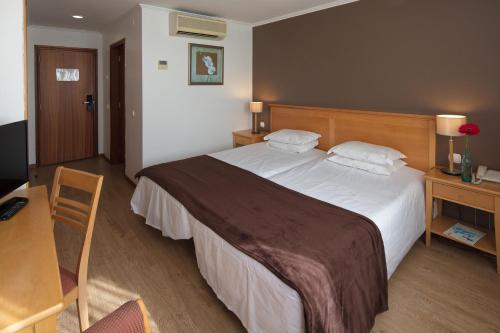 Uma cama ou camas num quarto em Hotel Orquidea