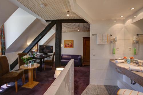 a bathroom with a sink and a shower and a desk at Trip Inn Hotel Blankenburg in Karlsruhe