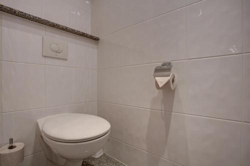 a white bathroom with a toilet in a room at Trip Inn Hotel Blankenburg in Karlsruhe