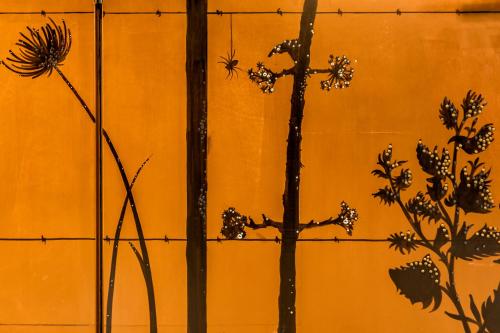 a plant on a wall next to a fence at Hotel Restaurant Au Boeuf Couronné in Paris