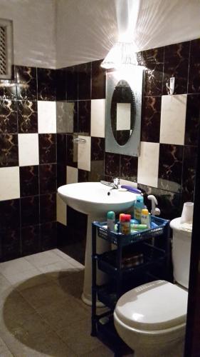 a bathroom with a sink and a toilet at Nimal`s Homestay in Hikkaduwa