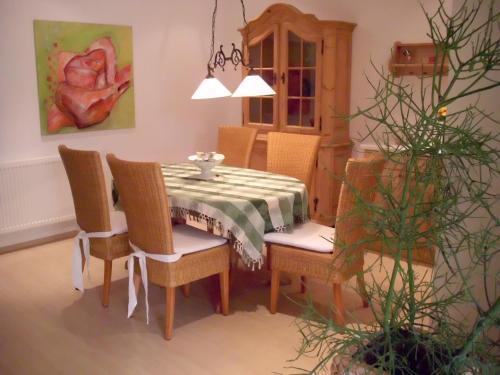 a dining room table and chairs with a table and a table and chairsktop at Villa Fleurie in Schledehausen