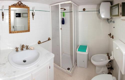a bathroom with a sink and a shower and a toilet at VaGiu' Dimora Storica in Tricase