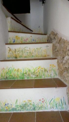 a set of stairs with flowers and plants painted on them at Cominium Benessere in Alvito