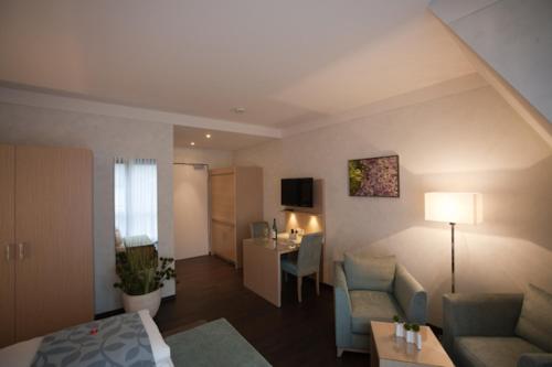 a living room with a couch and a table in a room at Weingut & Gästehaus Schmitz-Bergweiler in Bernkastel-Kues