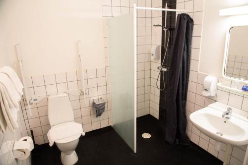 a bathroom with a toilet and a sink at Wärs - Wärdshuset på Dal in Mellerud