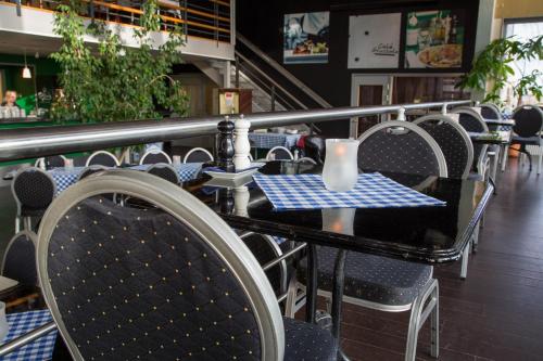 a row of tables and chairs in a restaurant at Dinners Mellerud in Mellerud